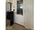 Utility room featuring a white paneled door with integrated window, adjacent to a water cooler at 2350 Brewer Dr, Indianapolis, IN 46227