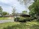 Well-kept single-story home surrounded by lush greenery, a paved driveway, and a two-car garage at 2350 Brewer Dr, Indianapolis, IN 46227