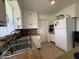 Traditional kitchen with white cabinetry, tile backsplash, stainless steel sink, and modern appliances at 2350 Brewer Dr, Indianapolis, IN 46227