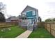 Large backyard with a deck, upper balcony, fire pit, and green lawn creating the perfect outdoor entertaining space at 2363 N Pennsylvania St, Indianapolis, IN 46205