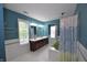 Stylish bathroom with teal walls, white tile, a standalone tub and & sinks at 2363 N Pennsylvania St, Indianapolis, IN 46205
