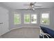 Bedroom featuring three windows, neutral carpet, and a ceiling fan at 2363 N Pennsylvania St, Indianapolis, IN 46205