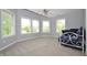 Bright bedroom with three windows, a ceiling fan, and carpeted floors at 2363 N Pennsylvania St, Indianapolis, IN 46205