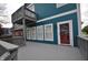 View of the exterior featuring a large deck and a red door at 2363 N Pennsylvania St, Indianapolis, IN 46205