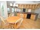 Charming dining area with hardwood floors, wood table set, and kitchen bar access at 2363 N Pennsylvania St, Indianapolis, IN 46205