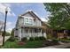 Charming two-story home boasts inviting front porch and colorful exterior paint at 2363 N Pennsylvania St, Indianapolis, IN 46205