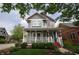 Beautiful two-story house with a welcoming front porch, nice landscaping, and colorful siding at 2363 N Pennsylvania St, Indianapolis, IN 46205