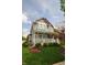 Charming two-story home with a covered front porch, well-manicured lawn, and colorful landscaping adding curb appeal at 2363 N Pennsylvania St, Indianapolis, IN 46205