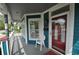 Inviting front porch with seating area, decorative pillars and front door with window adding unique character to the home at 2363 N Pennsylvania St, Indianapolis, IN 46205