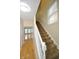 Bright hallway features hardwood floors, white staircase and natural light from windows at 2363 N Pennsylvania St, Indianapolis, IN 46205