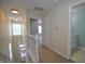 Bright hallway with white staircase and access to the laundry room at 2363 N Pennsylvania St, Indianapolis, IN 46205