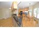 Eat-in kitchen with hardwood floors, wood cabinets, stainless appliances, and large windows at 2363 N Pennsylvania St, Indianapolis, IN 46205