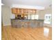 Open kitchen concept with hardwood floors, stone bar, and natural wood cabinets at 2363 N Pennsylvania St, Indianapolis, IN 46205
