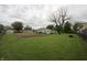 Large grassy backyard with mature trees and a view of neighboring houses at 2657 Mars Hill St, Indianapolis, IN 46241