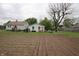 View of the home's spacious backyard featuring garden and swing set area at 2657 Mars Hill St, Indianapolis, IN 46241