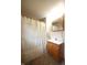 Cozy bathroom with wood vanity, shower with curtain, and neutral toned decor at 2657 Mars Hill St, Indianapolis, IN 46241