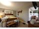 Bedroom with a wooden bed frame, neutral walls, and an archway leading to the kitchen at 2657 Mars Hill St, Indianapolis, IN 46241