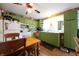 Vintage kitchen with green cabinets, an eat-in table, and unique Coca-Cola themed decor at 2657 Mars Hill St, Indianapolis, IN 46241
