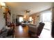 Cozy living room with hardwood floors, a ceiling fan, and a comfortable seating arrangement at 2657 Mars Hill St, Indianapolis, IN 46241