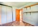 Bedroom with blue-painted walls, tile floors, open shelves, and a closet at 2842 Sangster Ave, Indianapolis, IN 46218