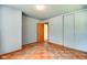 Bedroom featuring original hardwood floors, closet and door at 2842 Sangster Ave, Indianapolis, IN 46218