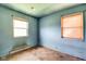 This bedroom features tile floors, two windows, and blue-painted walls at 2842 Sangster Ave, Indianapolis, IN 46218