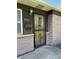 Close up of the front door with security gate and brick exterior at 2842 Sangster Ave, Indianapolis, IN 46218
