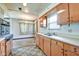 Kitchen featuring laminate countertop, wood cabinetry, and open layout at 2842 Sangster Ave, Indianapolis, IN 46218