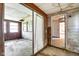 View of the living room with a sliding door and wood paneling at 2842 Sangster Ave, Indianapolis, IN 46218