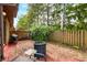 Spacious backyard area featuring wood fence, mature trees, and portable cold pod at 3165 Sycamore Dr, Columbus, IN 47203