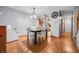 Bright dining area with wood floors, modern chandelier, and easy access to kitchen at 3165 Sycamore Dr, Columbus, IN 47203