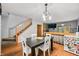 Open dining room featuring a staircase, views to living room, and a modern light fixture at 3165 Sycamore Dr, Columbus, IN 47203