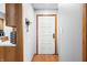 Entryway features a white door with wood trim and wood-look flooring at 3165 Sycamore Dr, Columbus, IN 47203