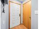 Entryway with a white front door, wood-look flooring, and light gray walls at 3165 Sycamore Dr, Columbus, IN 47203