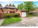 This two-story townhome features a detached garage, fenced yard and mature trees at 3165 Sycamore Dr, Columbus, IN 47203