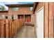 Townhome exterior featuring a red front door with stone accents and wood fencing at 3165 Sycamore Dr, Columbus, IN 47203