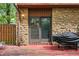 Cozy patio with stone accents, sliding glass doors, and weathered wood flooring at 3165 Sycamore Dr, Columbus, IN 47203