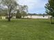 Expansive backyard featuring a lush lawn and mature trees, offering ample space at 3209 Pebblebrook Dr, Elwood, IN 46036