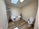 Bright bathroom featuring a modern soaking tub, skylight, and stylish fixtures at 3209 Pebblebrook Dr, Elwood, IN 46036
