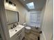 This bathroom offers a skylight and contemporary fixtures and a bright, refreshing space at 3209 Pebblebrook Dr, Elwood, IN 46036