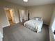 Bedroom with neutral carpet, white trim, and multiple closet doors at 3209 Pebblebrook Dr, Elwood, IN 46036