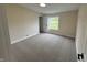 Bedroom with neutral carpet, large window, and white trim at 3209 Pebblebrook Dr, Elwood, IN 46036
