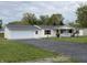 Charming single-story home with attached garage, long driveway, and inviting front porch at 3209 Pebblebrook Dr, Elwood, IN 46036