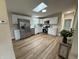 Bright kitchen with stainless steel appliances, white cabinets, light wood floors, and skylights at 3209 Pebblebrook Dr, Elwood, IN 46036