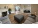 Spacious open-concept living space with sleek flooring, a fireplace, and a view into the dining area at 3209 Pebblebrook Dr, Elwood, IN 46036