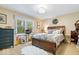 Bright bedroom featuring a full bed, natural light, and tasteful decor at 3444 Briar Pl, Carmel, IN 46033