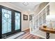 Inviting entryway features a glass front door, hardwood floors, a staircase, and neutral paint at 3444 Briar Pl, Carmel, IN 46033