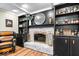 Stylish entertaining space with a brick fireplace, built-in shelving, and modern decor accents at 3444 Briar Pl, Carmel, IN 46033