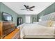Comfortable main bedroom with hardwood floors, a plush bed, and a view of the television at 3444 Briar Pl, Carmel, IN 46033