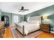 Spacious main bedroom featuring a large bed, hardwood floors, and a comfortable seating area at 3444 Briar Pl, Carmel, IN 46033